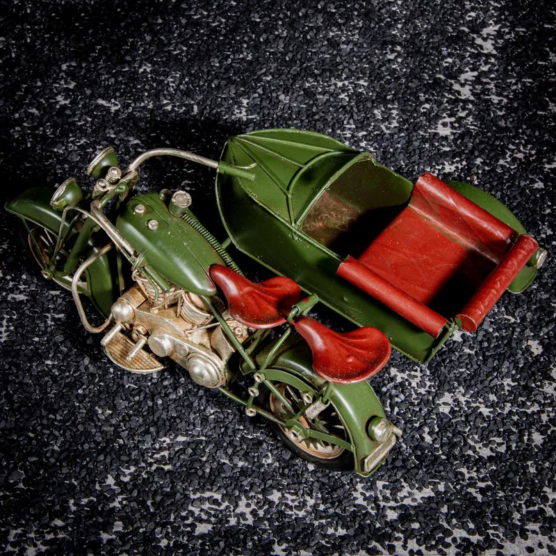 Top view of green motorcycle with sidecar showpiece and red seats