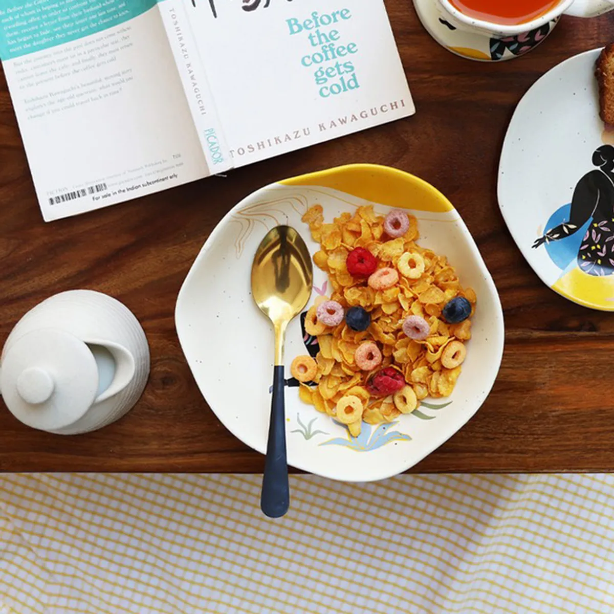 Top view of pasta plate with cereal, berries and a colourful illustrated surface