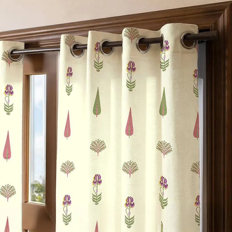 Close-up of off-white curtain with green and pink botanical print and eyelet top