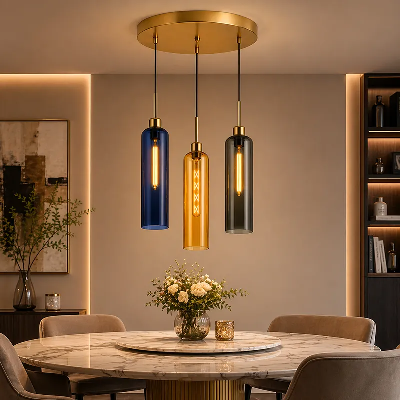 Clustered pendant ceiling lamp with three coloured cylindrical glass shades above a dining table