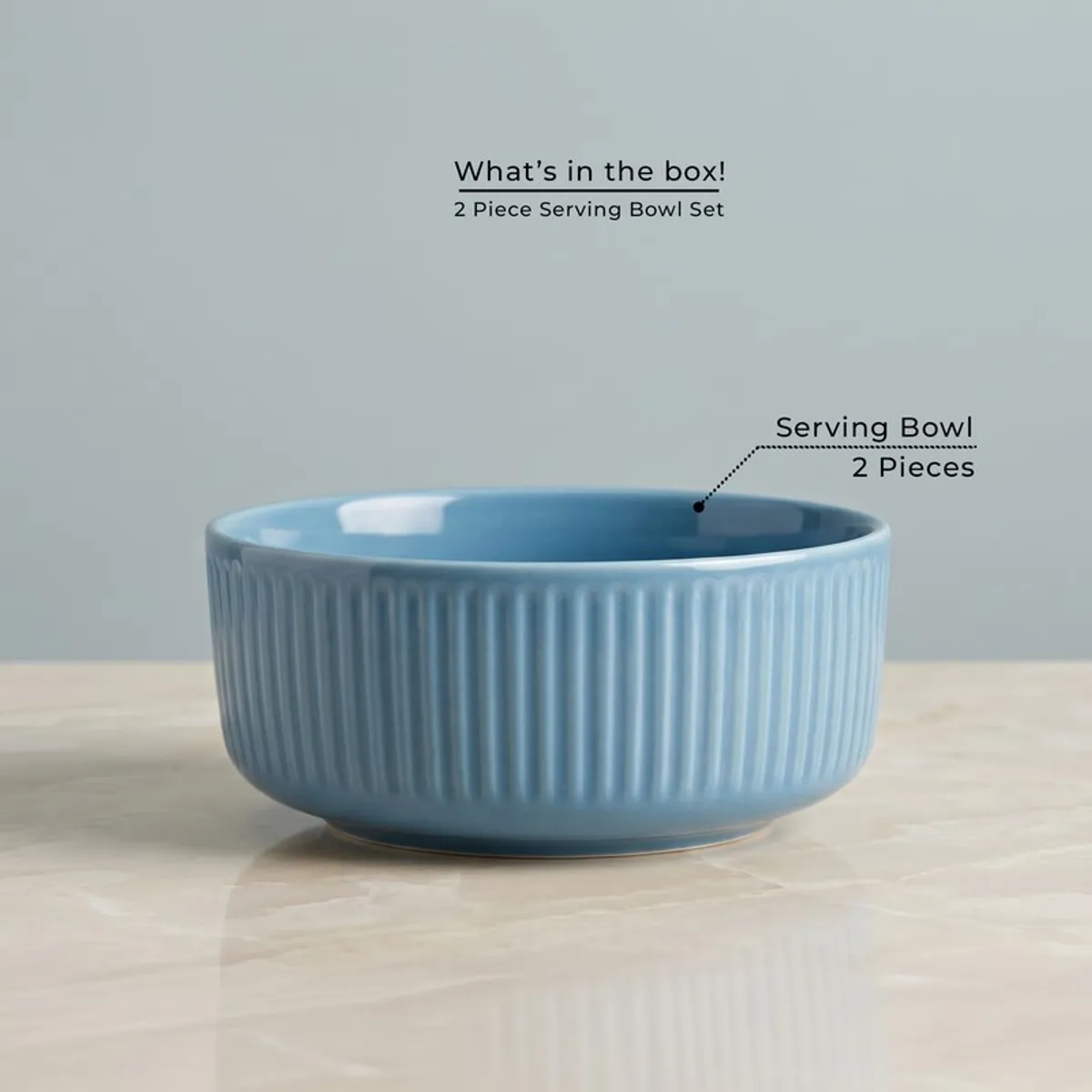 Single blue round ribbed serving bowl on a tabletop
