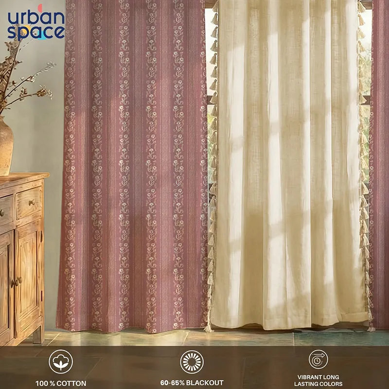 Pink floral curtains paired with off-white curtain panels in a sunlit room