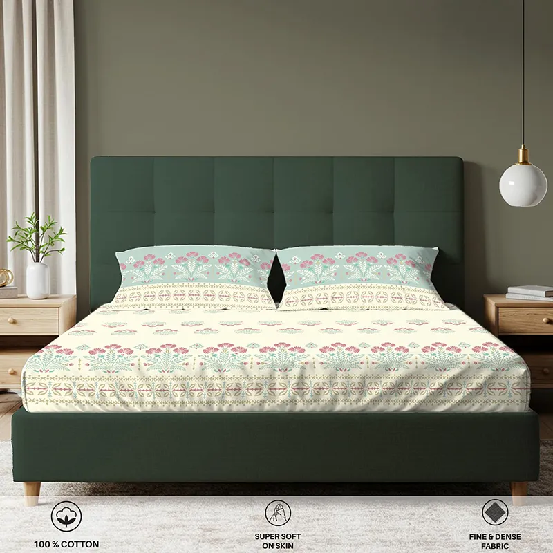 Front view of floral fitted bedsheet with matching pillow covers on a green bed