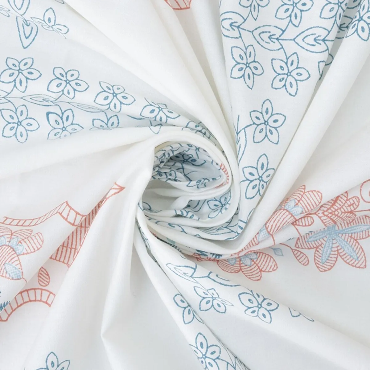 Close-up of soft white fabric with blue and coral floral prints