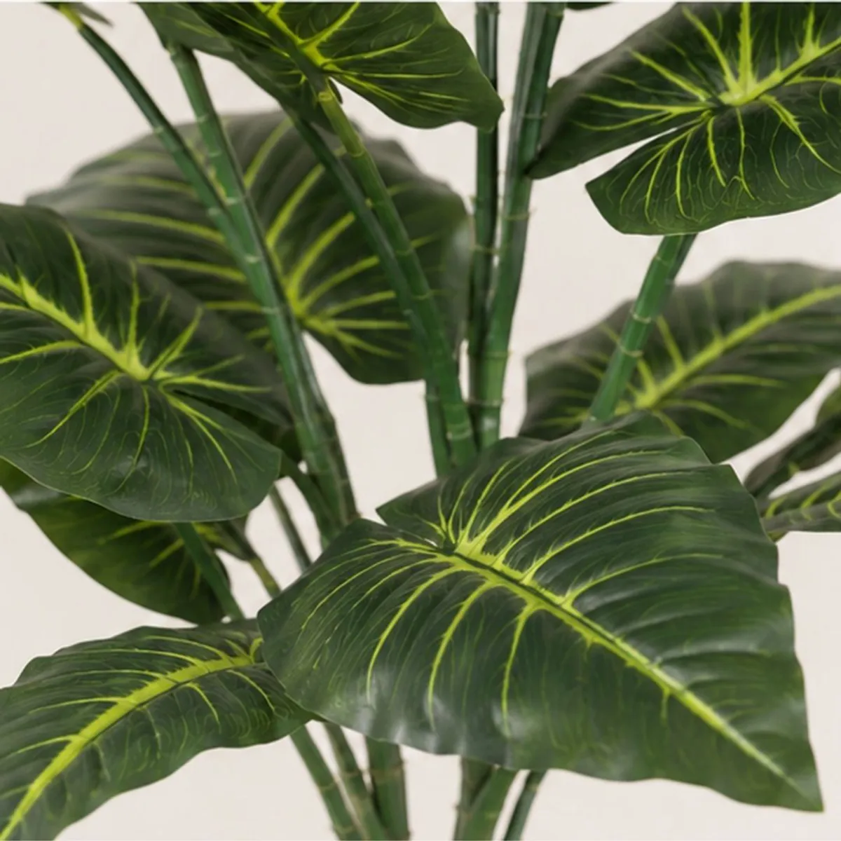 Close-up of dark green artificial leaves with bright vein detailing and green stems
