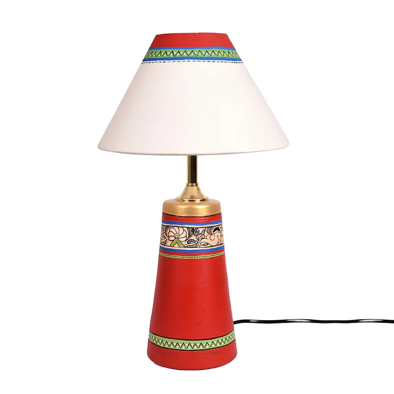 Red terracotta table lamp with cream conical shade on a white background