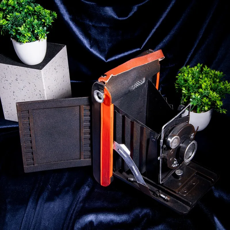 Vintage camera decor showpiece in black and red with side panel open