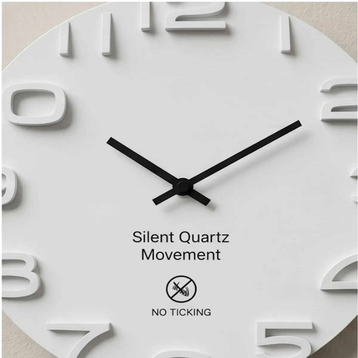 Close-up of raised white numerals and black clock hands on a minimalist dial