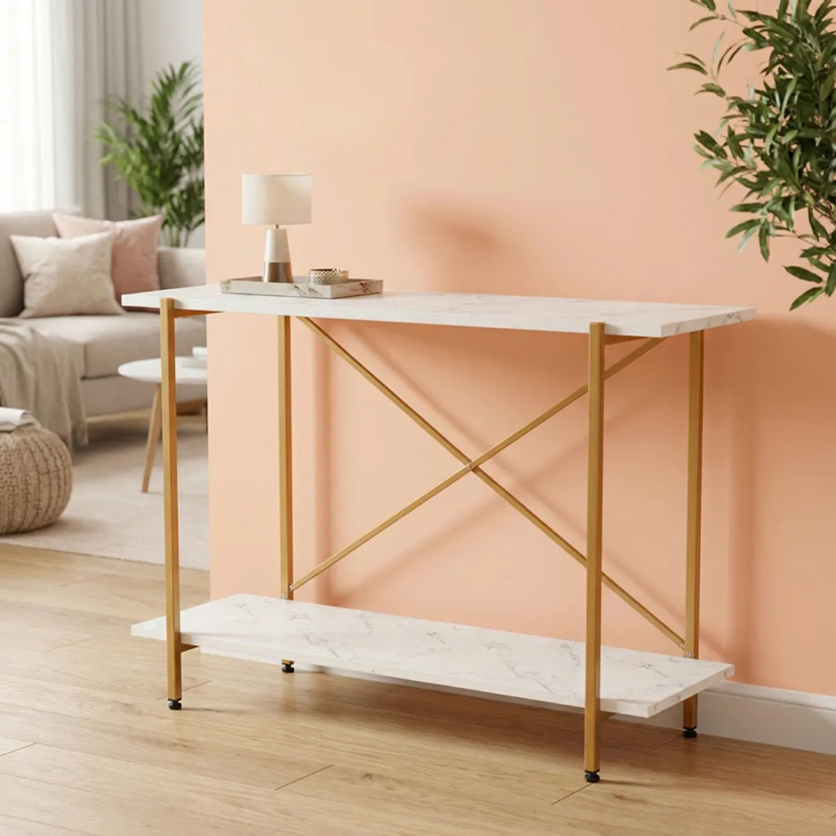 Slim white and gold console table against a peach wall in a living room