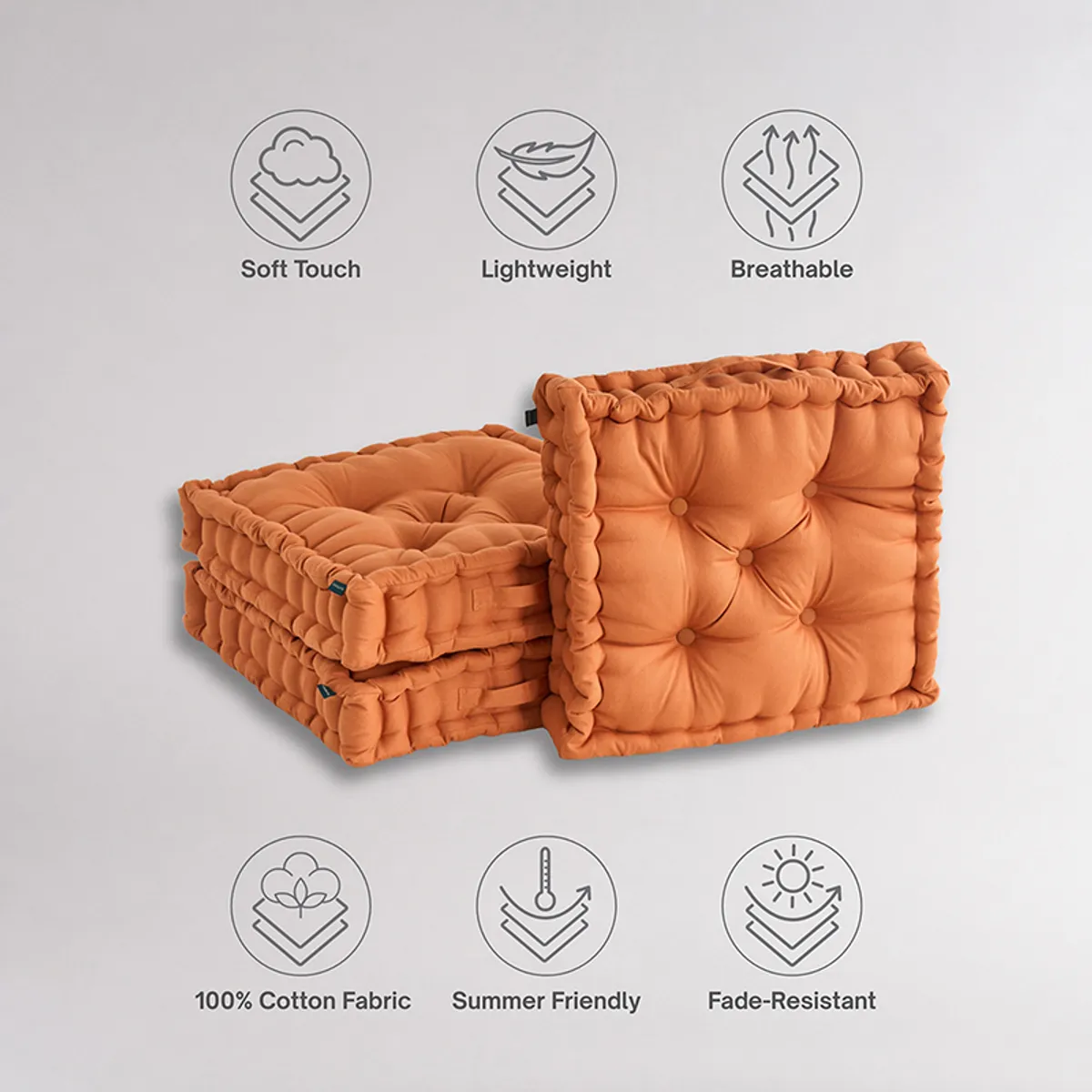 Two brown tufted floor cushions stacked with one upright, showing their soft quilted surfaces.