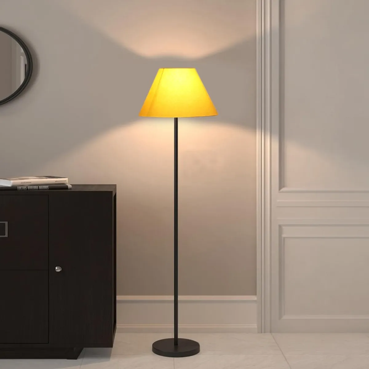 Yellow shade floor lamp lit beside a dark cabinet and pale wall