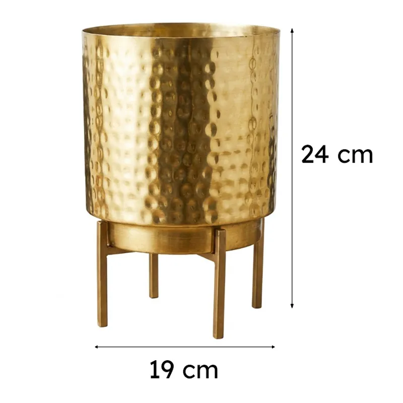 Gold hammered planter with stand on a white background
