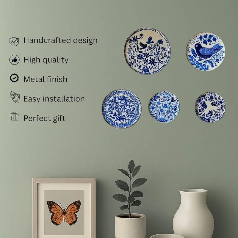 Five blue-and-white wall plates displayed in a neat arrangement