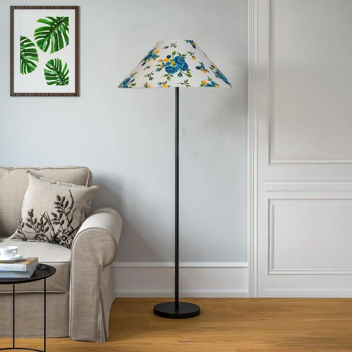 Blue floral floor lamp styled beside a beige sofa in a bright room