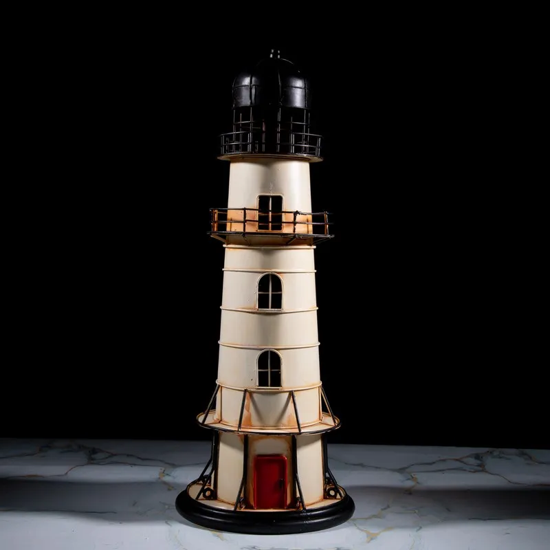 Front view of ivory lighthouse showpiece with black top against a dark background