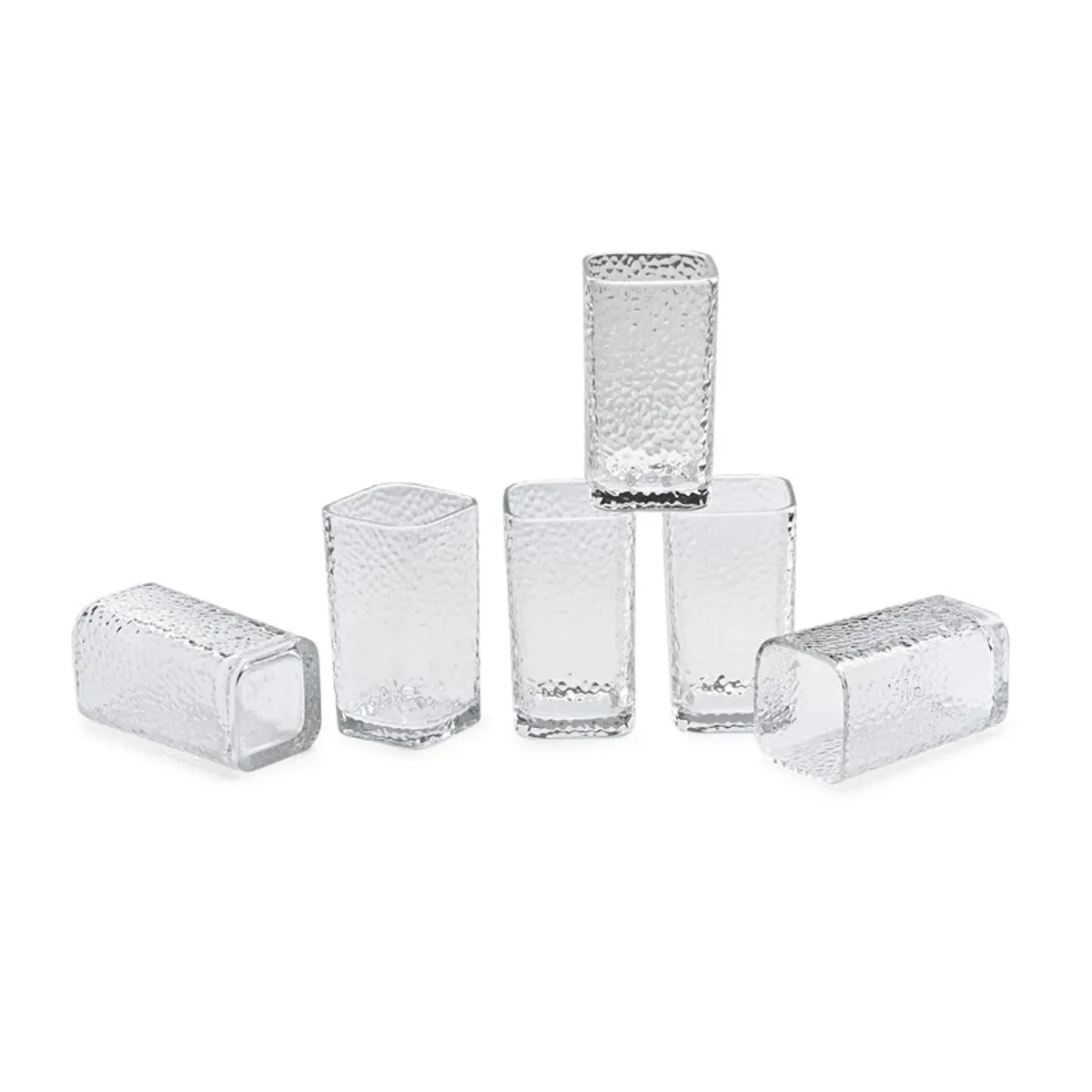 Six clear textured drinking glasses arranged on a white background