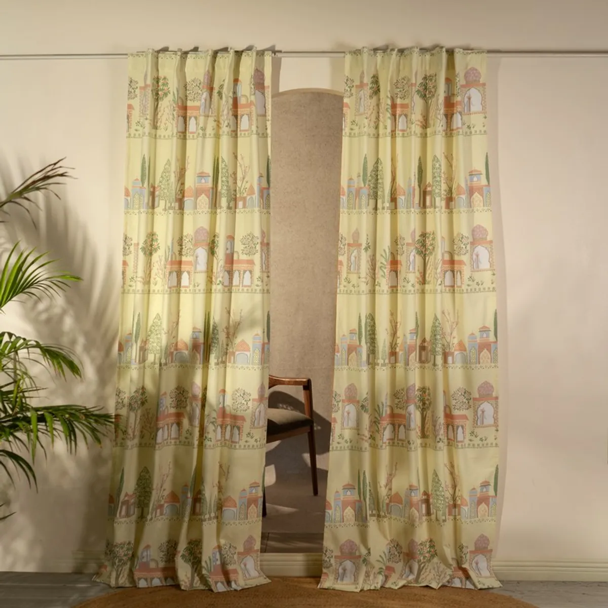 Pair of yellow patterned curtains framing a doorway in a bright room