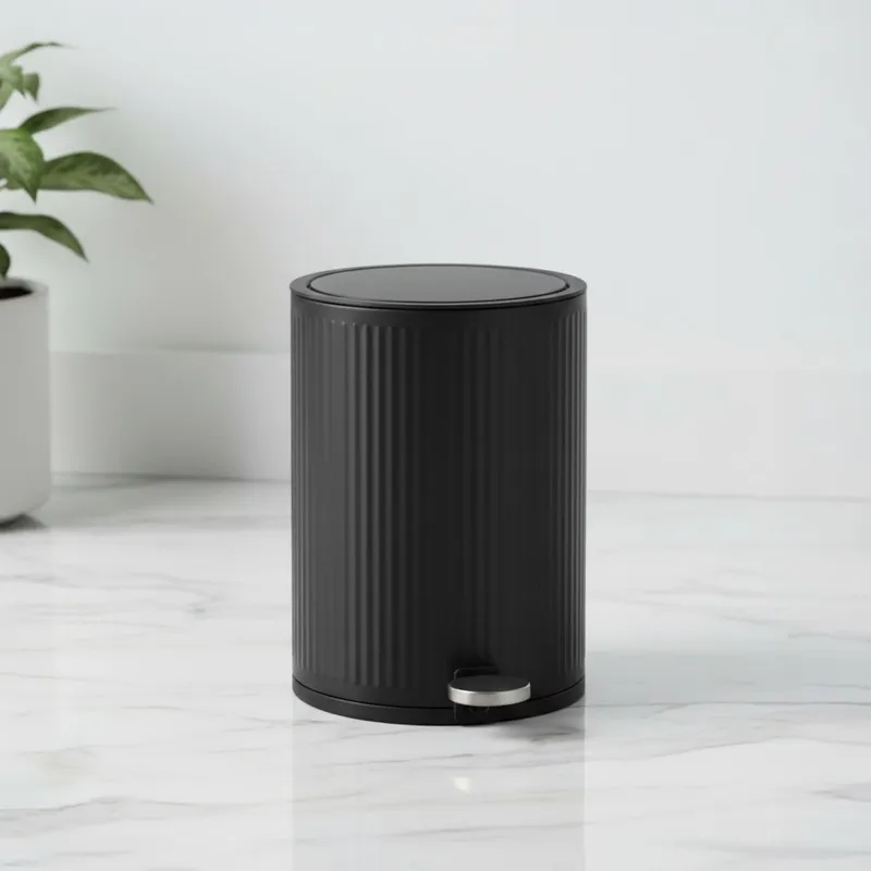 Black cylindrical dustbin with ribbed sides and pedal lid closed