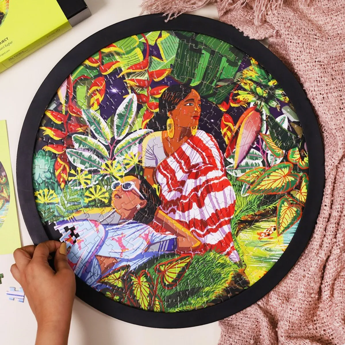 Close-up of the round garden puzzle wall art with colourful figurative artwork