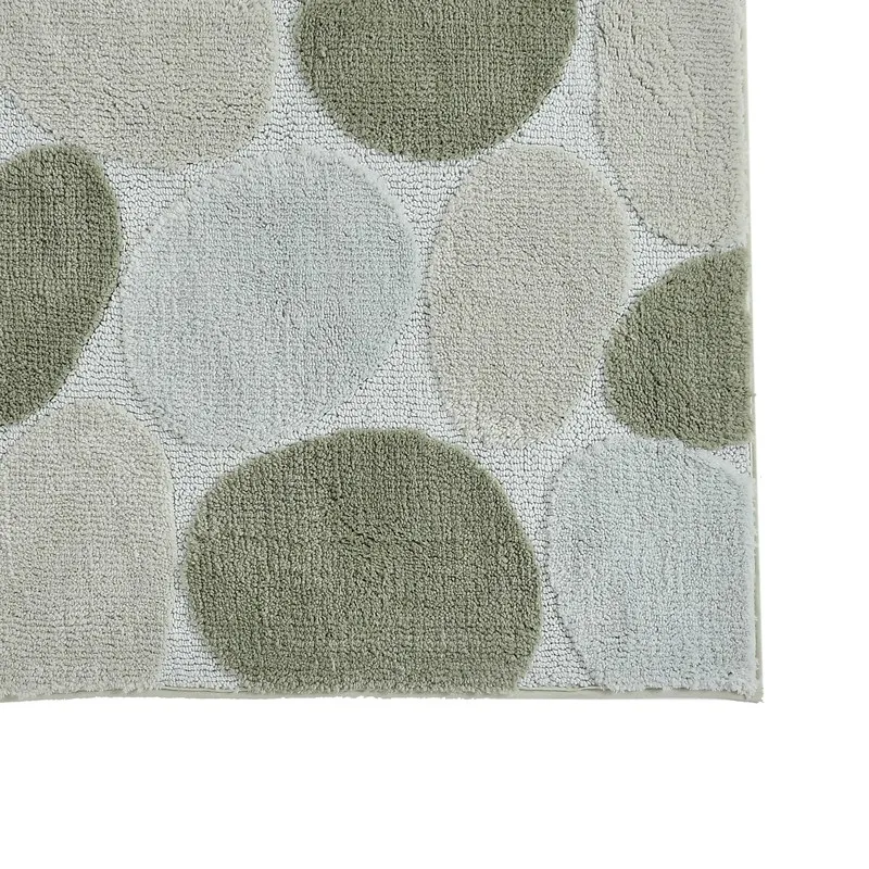Close-up of sage green and off-white abstract stone pattern on bath mat