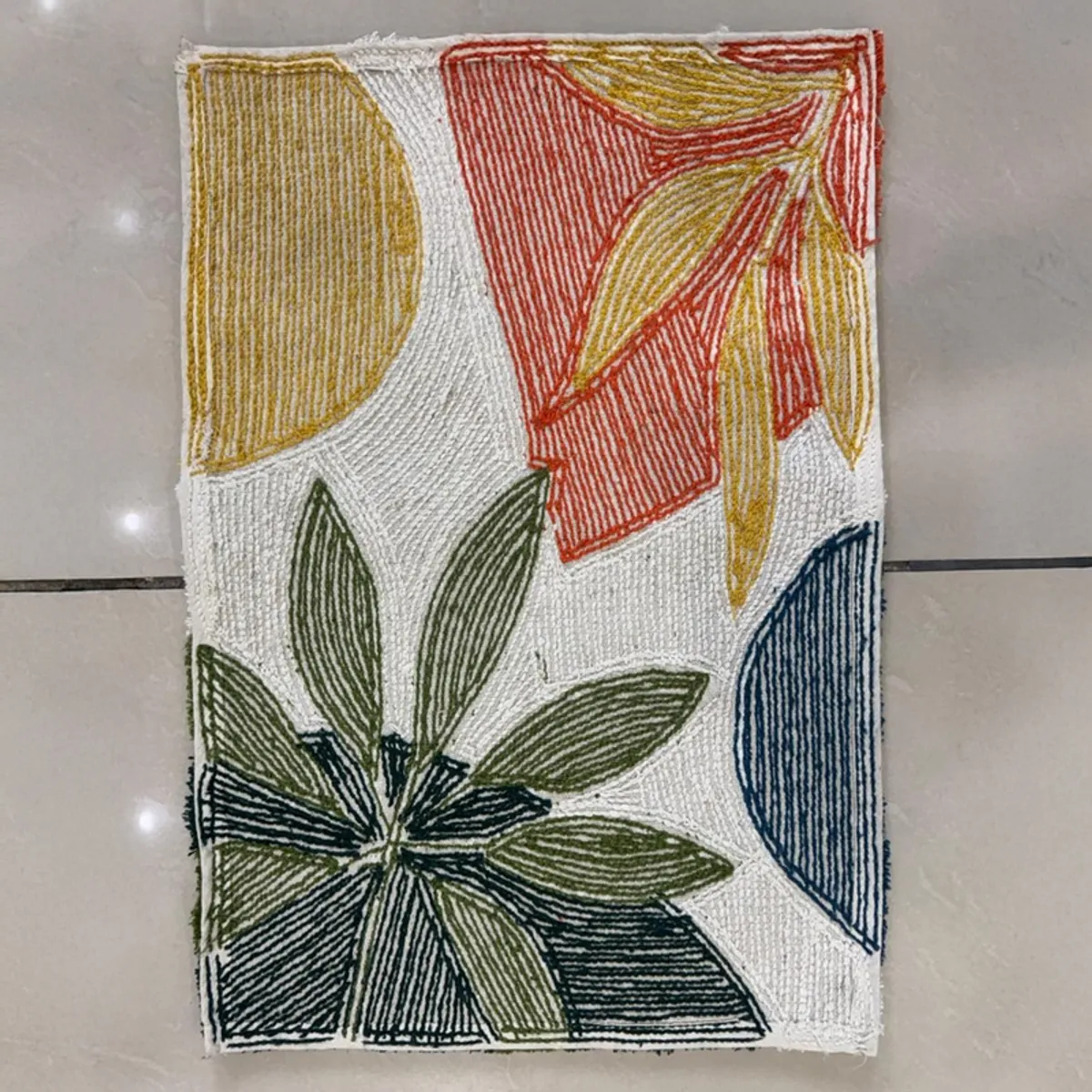 Back view showing the textured underside of the botanical bath mat.