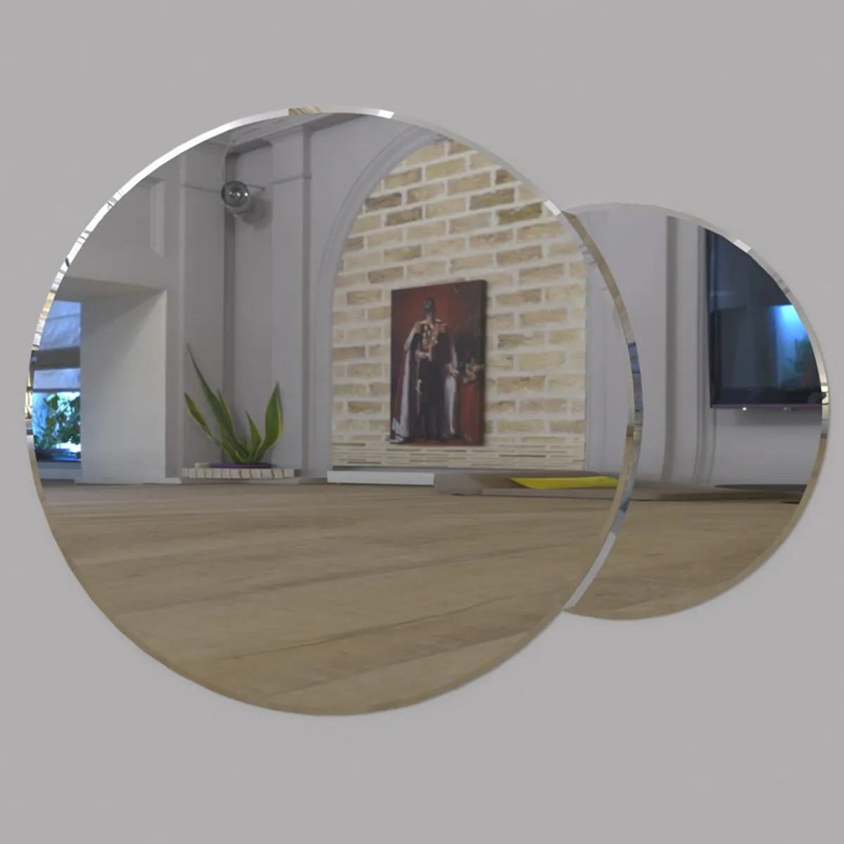 Two overlapping round silver wall mirrors reflecting a contemporary living room