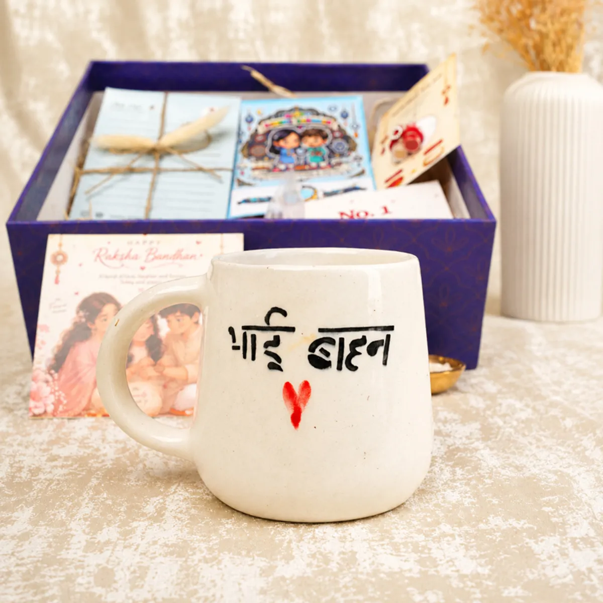 Bhai Behan mug displayed in front of an open Raksha Bandhan hamper.