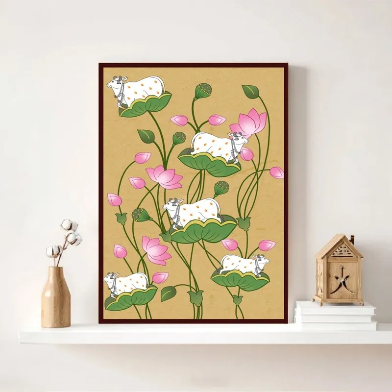 Rectangular framed wall art with sacred cow and lotus motif displayed on a white shelf