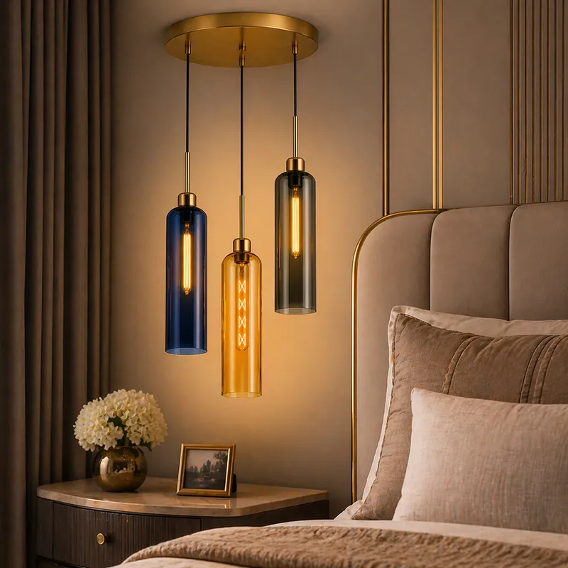 Three-light glass ceiling lamp with blue, amber and smoky shades in a bedroom setting