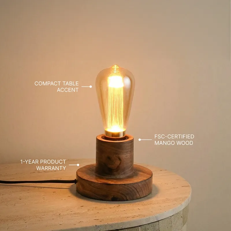 Brown wooden table lamp with glowing glass bulb on a round side table