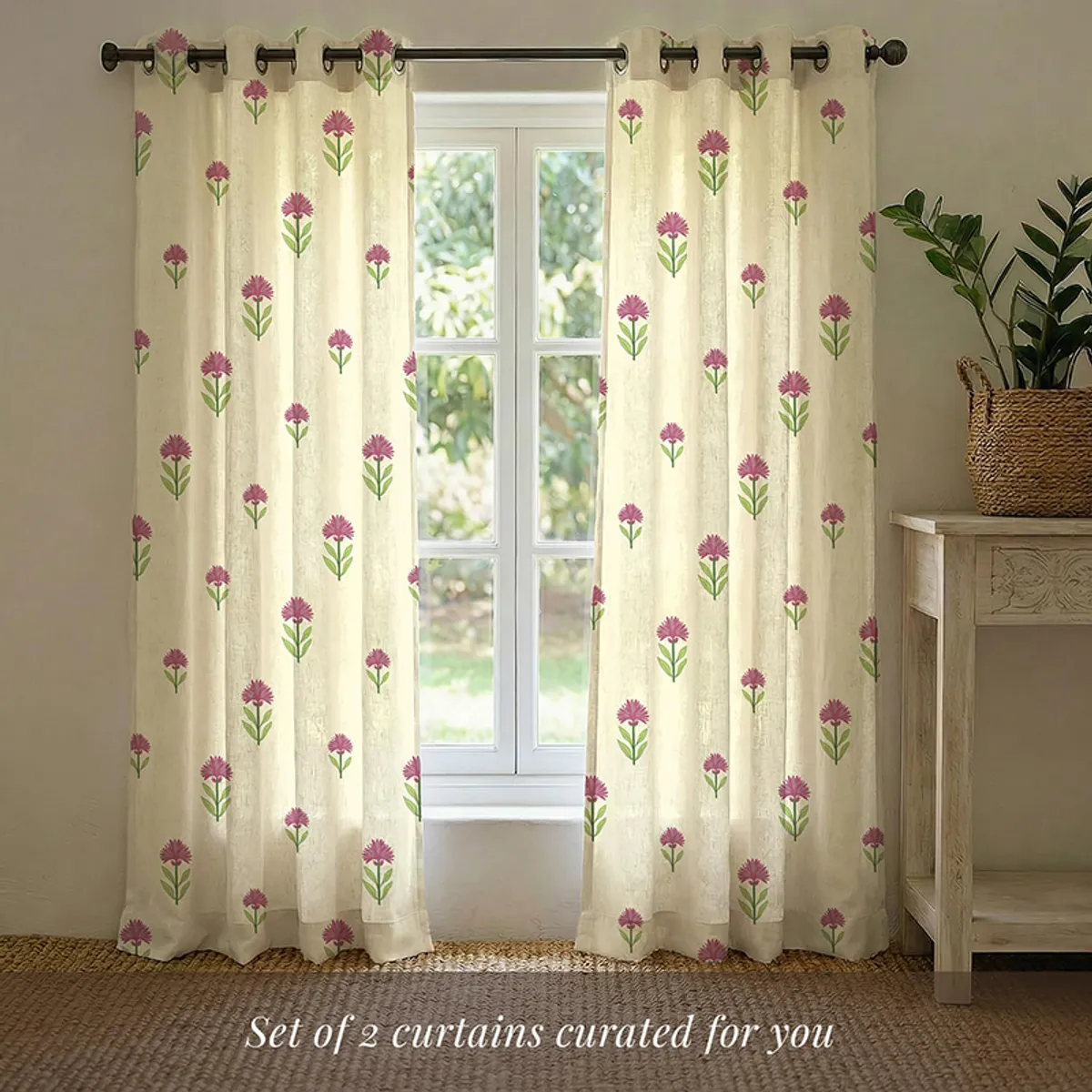 Two floral curtains displayed on a window with eyelet rings.