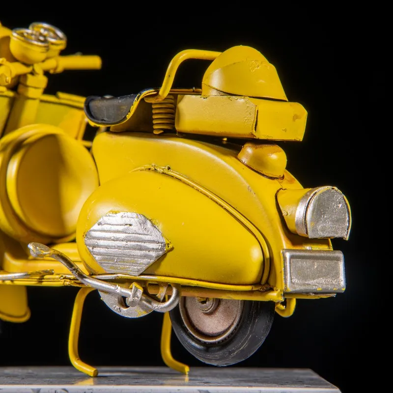 Close-up of rear section of yellow scooter metal showpiece