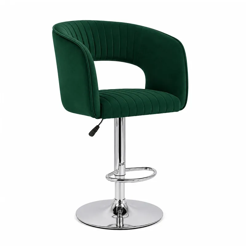 Angled view of green velvet bar chair with curved arms and chrome pedestal base