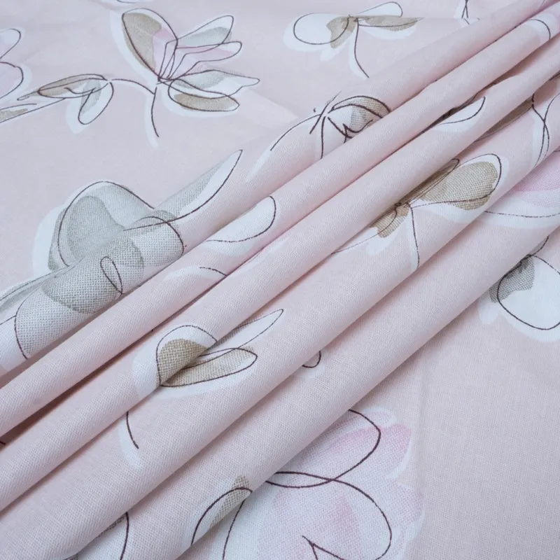 Folded pink floral bedsheet fabric in close detail
