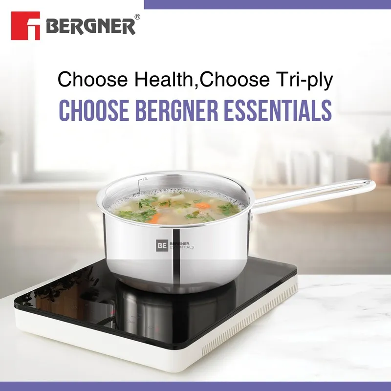 Silver saucepan containing soup on a compact induction cooktop