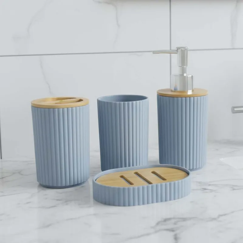 Grey ribbed bathroom accessories arranged on a marble countertop