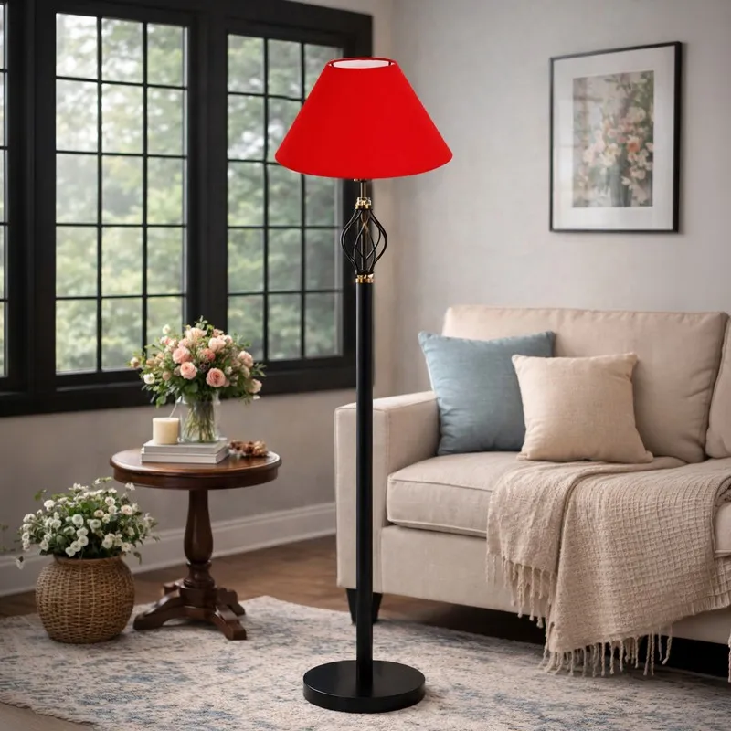 Red shade floor lamp in a living room beside a sofa and round table