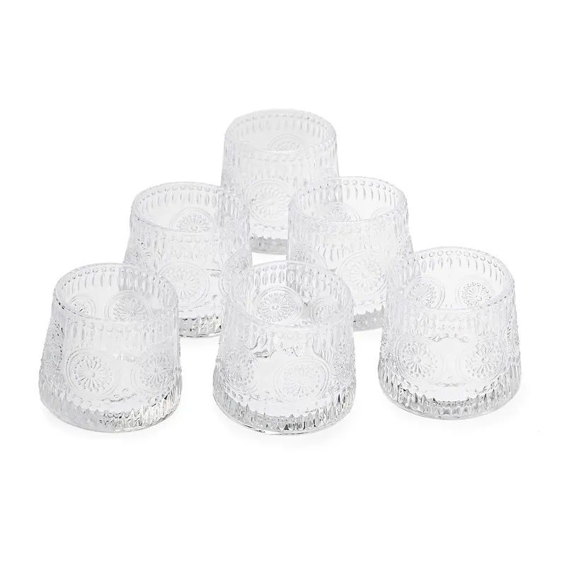 Set of six clear glass whiskey tumblers on a white background