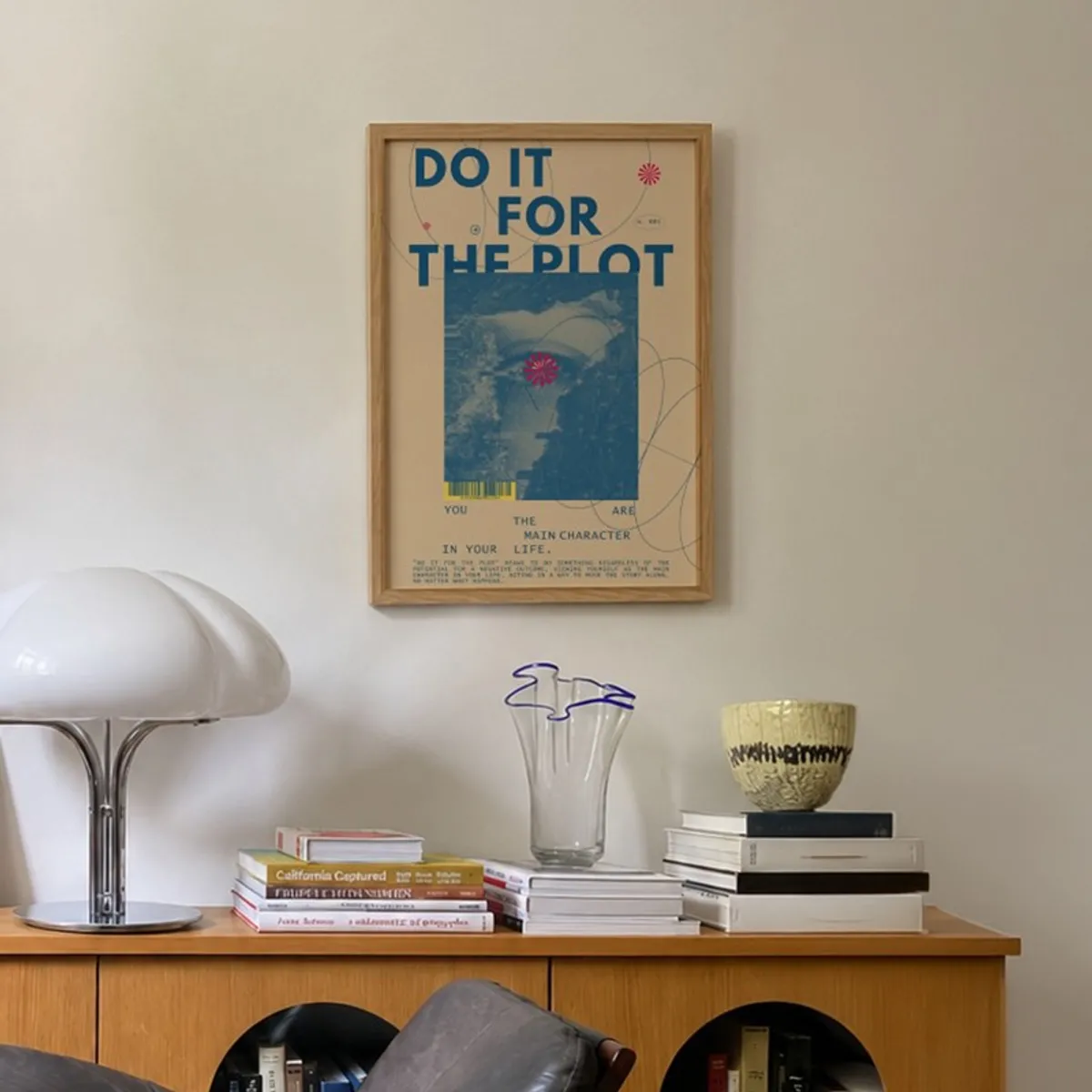 Framed blue and beige wall art above a wooden sideboard