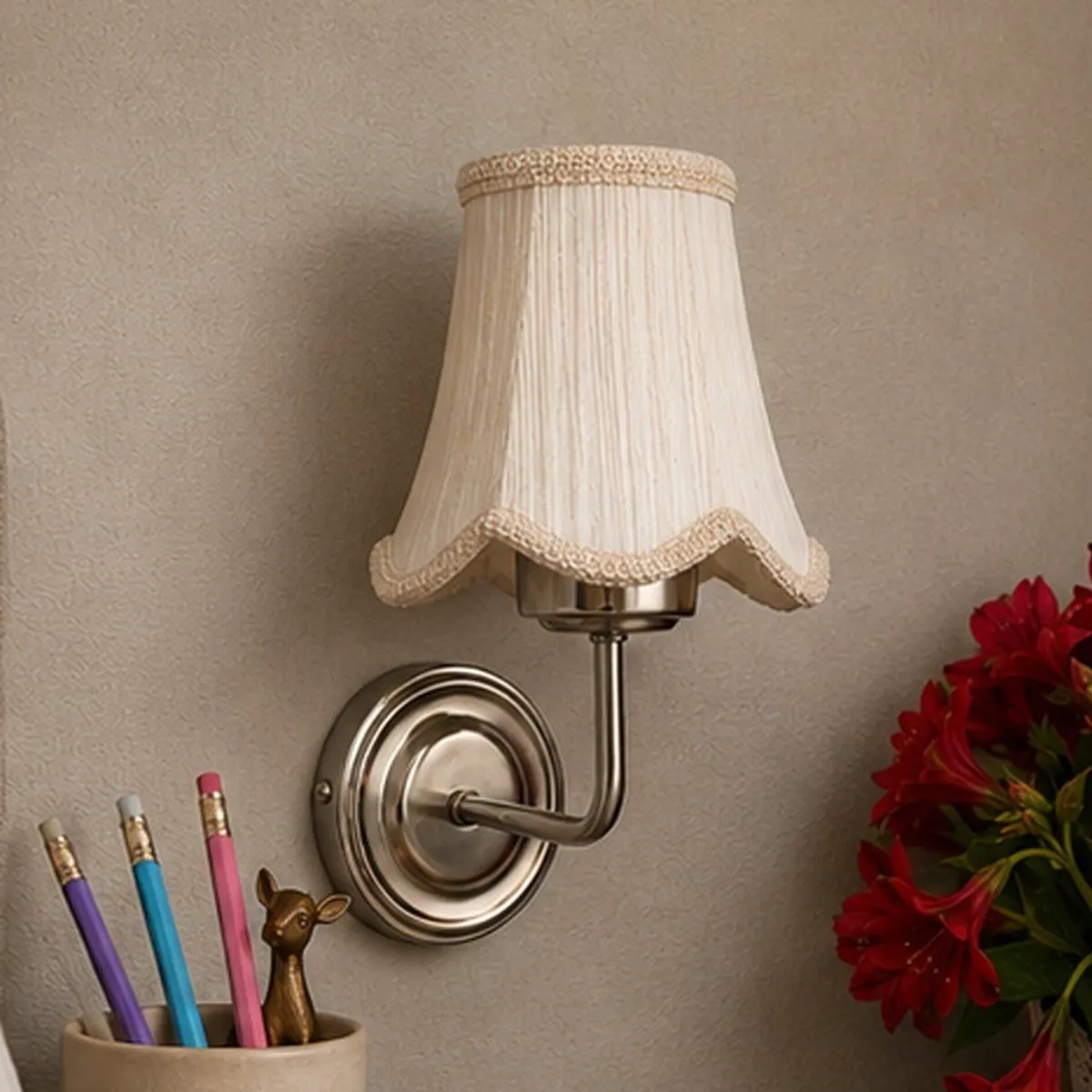 White cotton-shade wall lamp with scalloped trim and a steel base