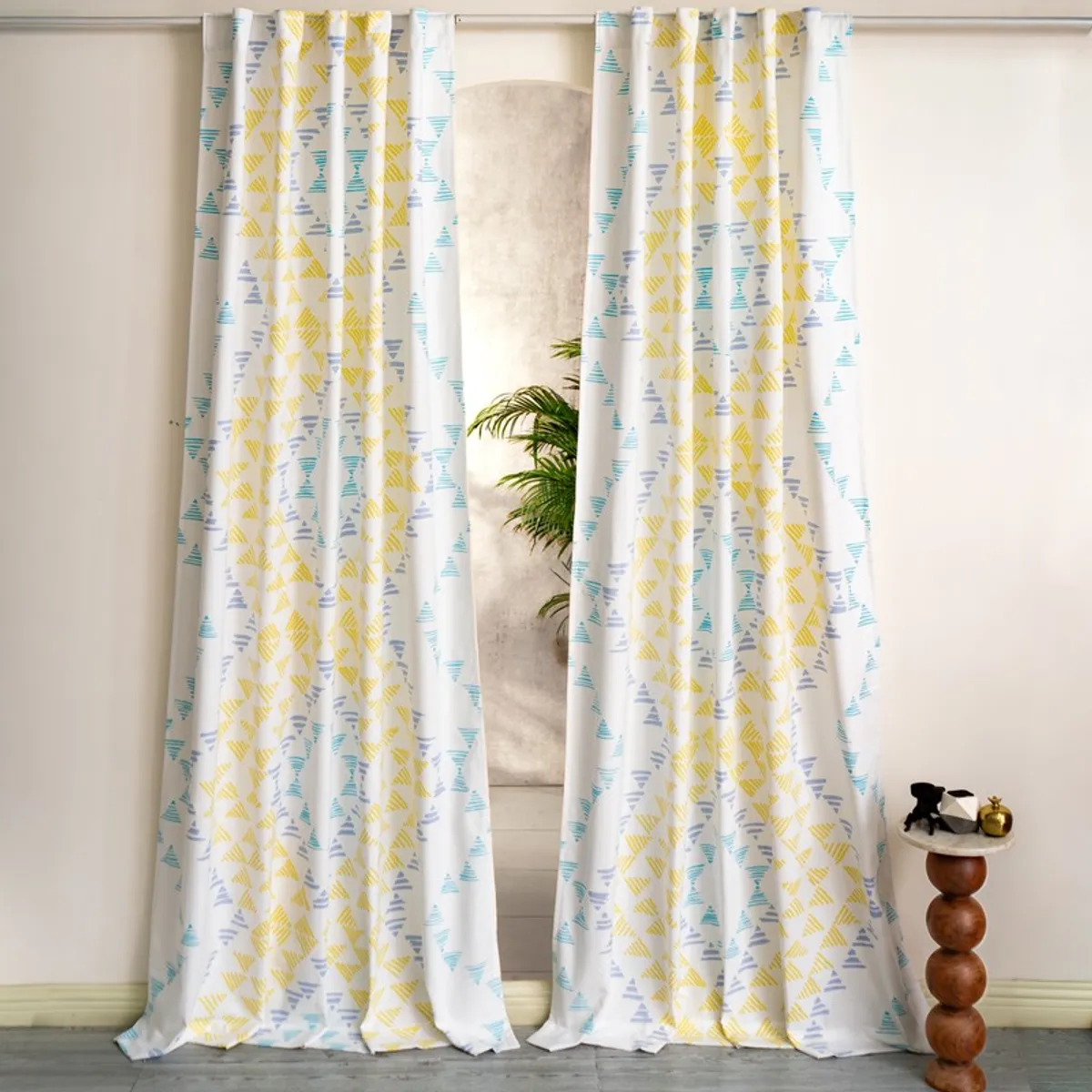 Pair of patterned curtains framing a window in a bright room