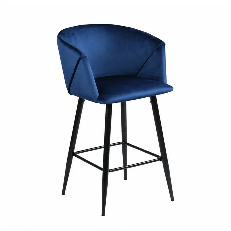 Angled view of blue velvet bar chair with curved back and black legs