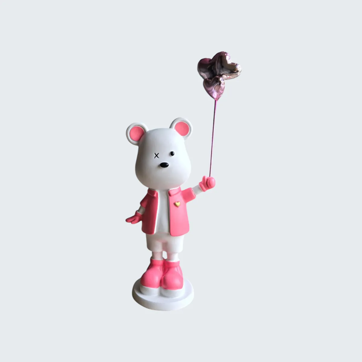 Front view of a pink and white bear showpiece with a heart balloon