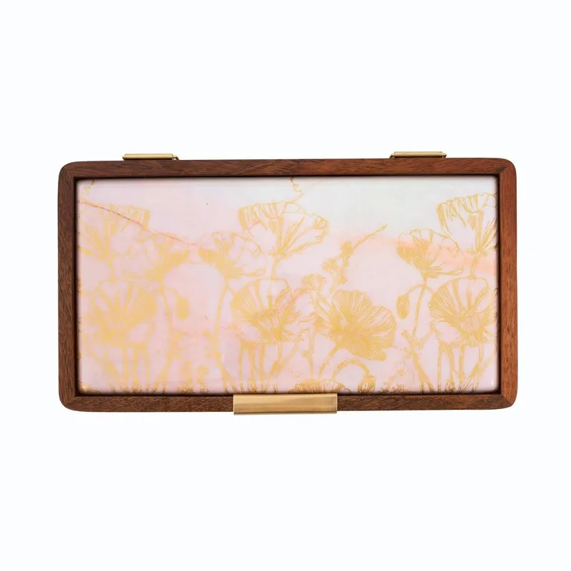 Top view of a brown masala box with a pale lid and gold floral pattern