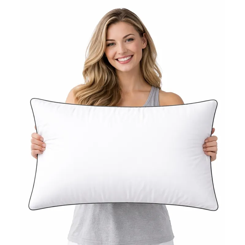 Person holding a white rectangular pillow filler with dark piping
