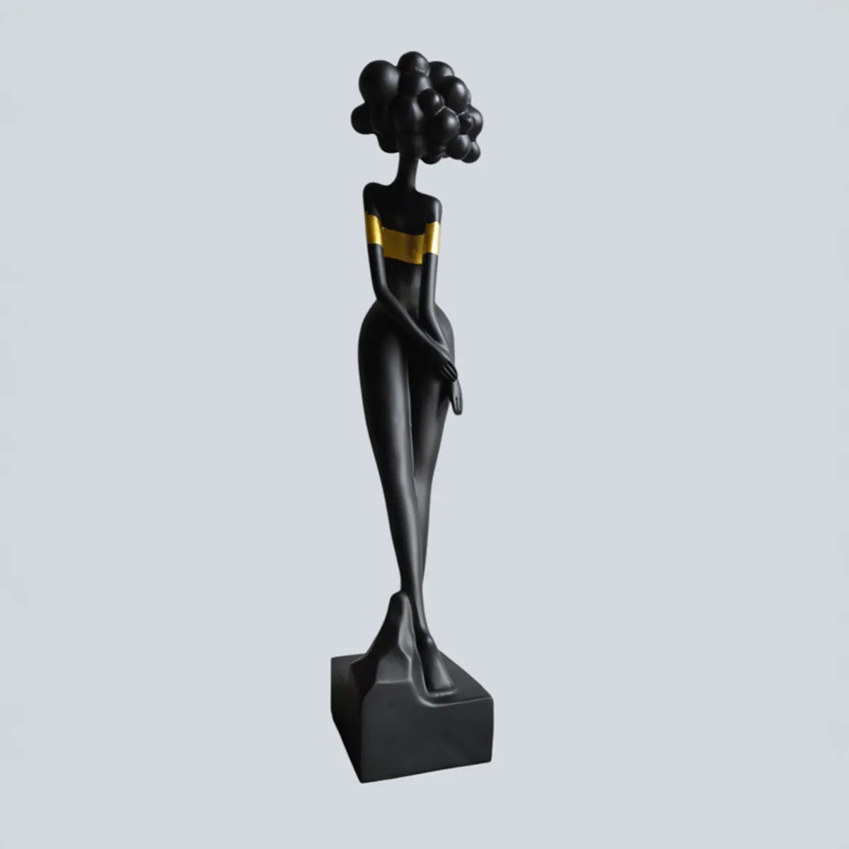 Rear view of a black lady figurine with gold bands and bubble-style hair
