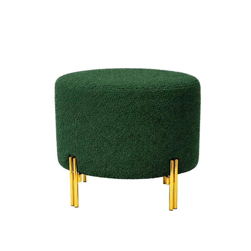 Green round bouclé ottoman with gold legs shown against a white background