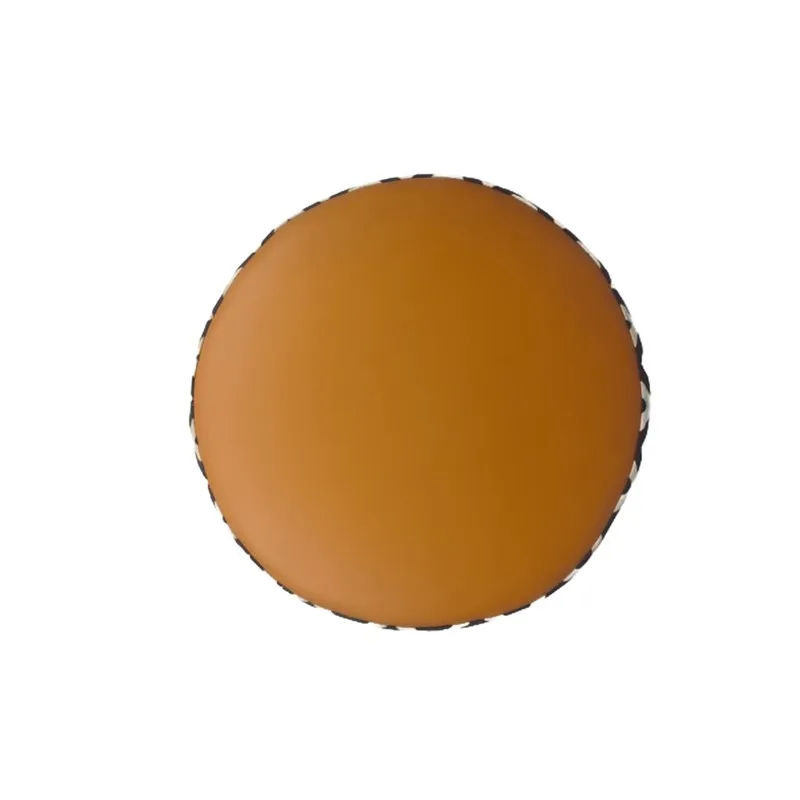 Top view showing the round brown seat of the ottoman