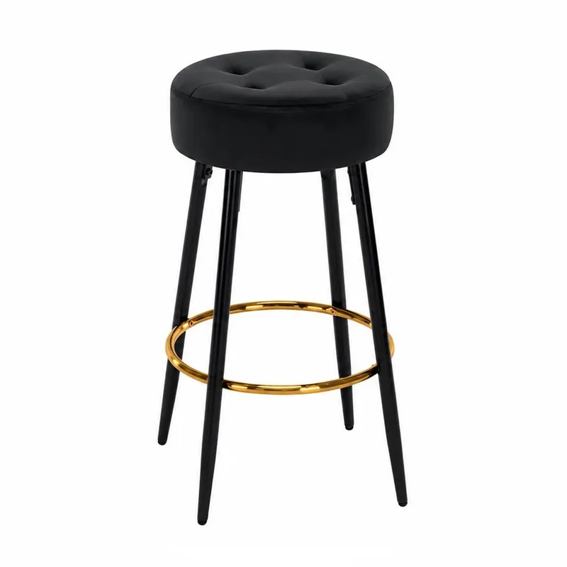 Black round bar stool with slim legs and gold circular footrest