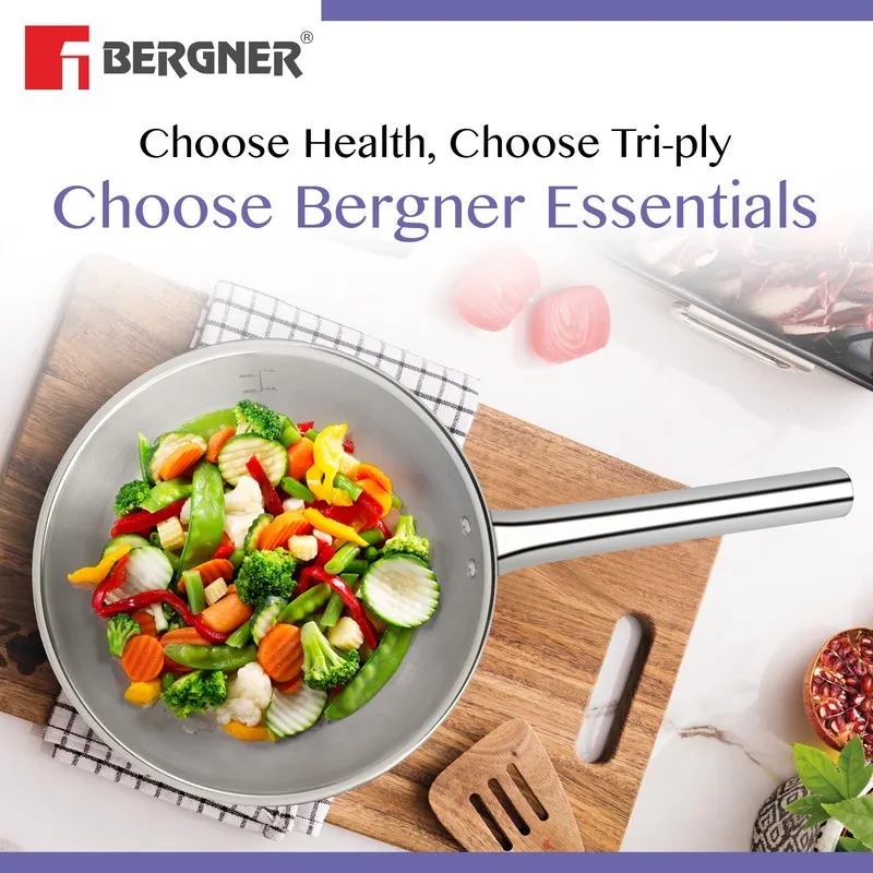 Silver frying pan filled with colourful vegetables on a wooden board